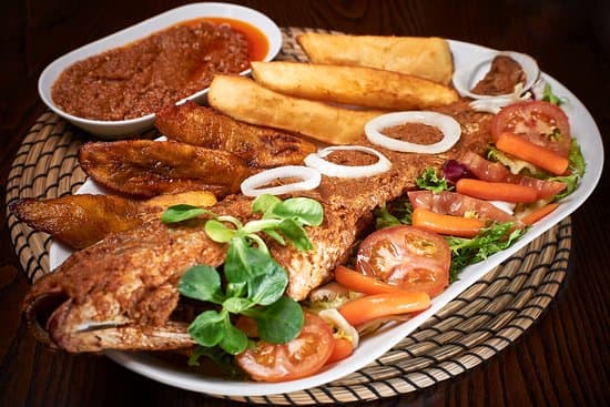 Grilled Atlantic Croaker served with fried yam, plantain and vegetables